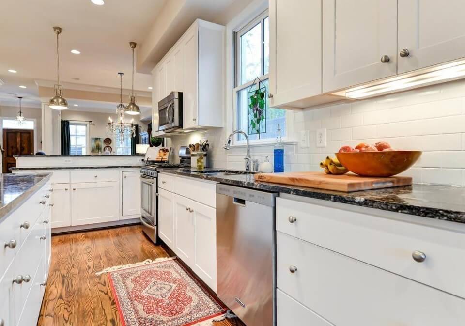 White Subway Backsplash Tile with Granite Counters in Kitchen